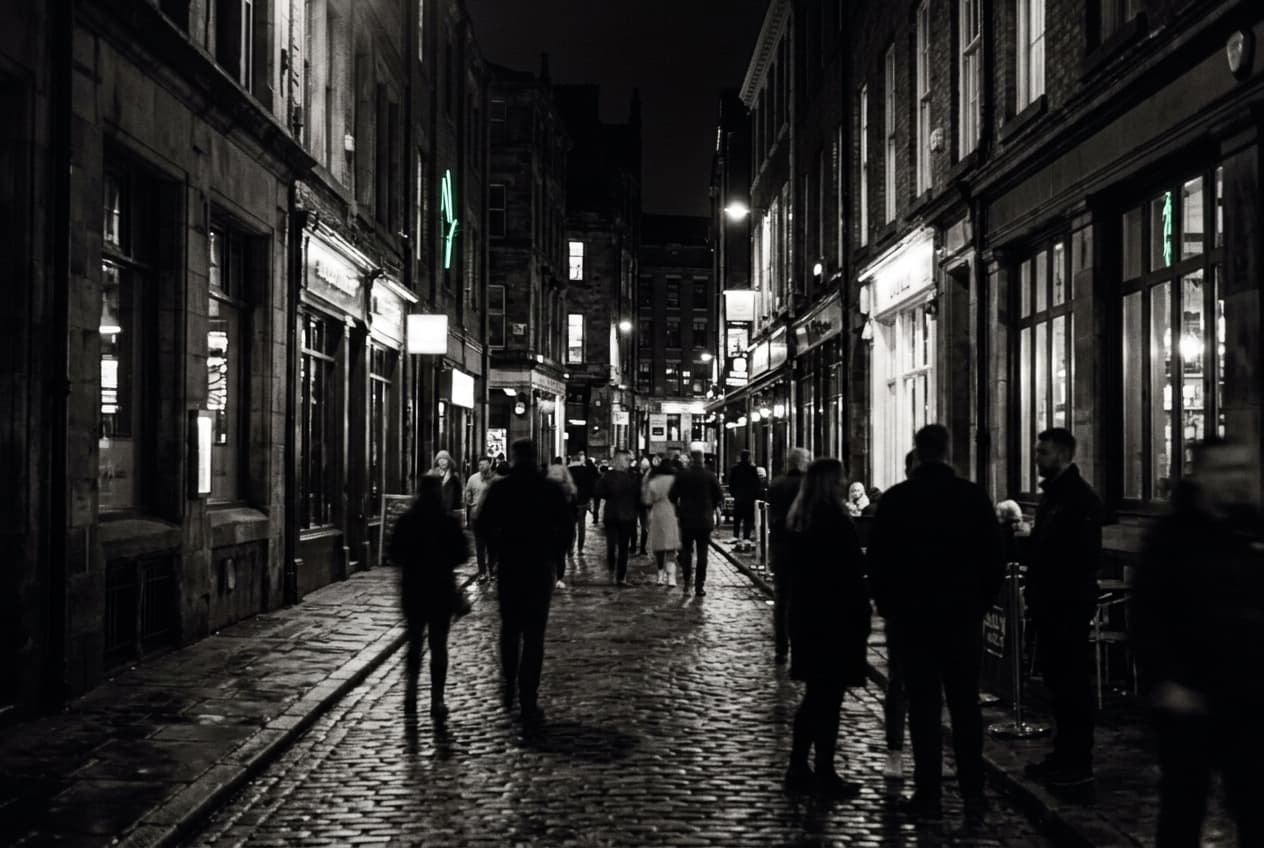 Cobbled Liverpool street at night lined with glowing restaurant windows